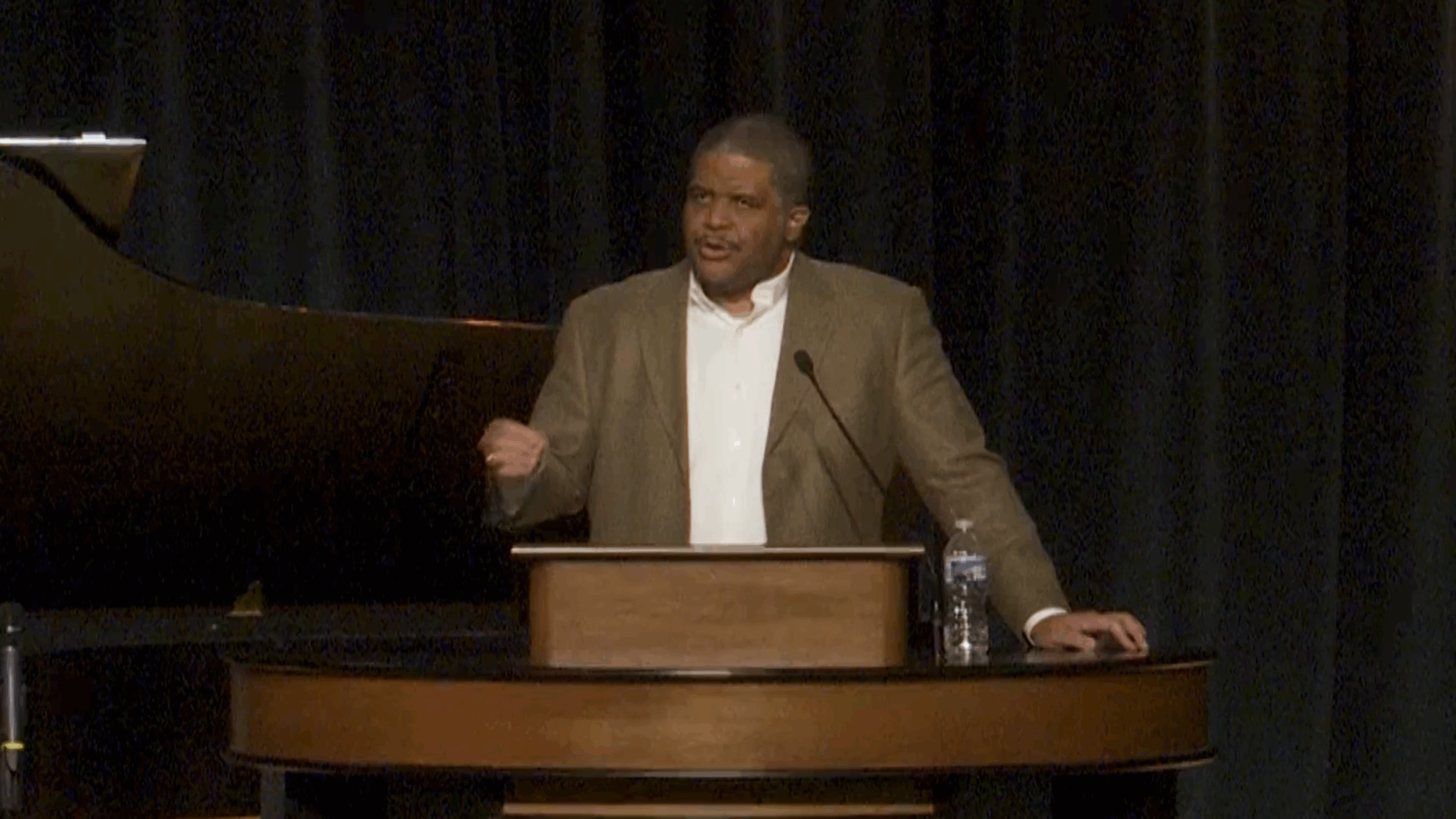 Keith Plummer standing behind chapel podium