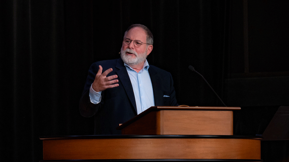 Todd Williams standing behind chapel podium